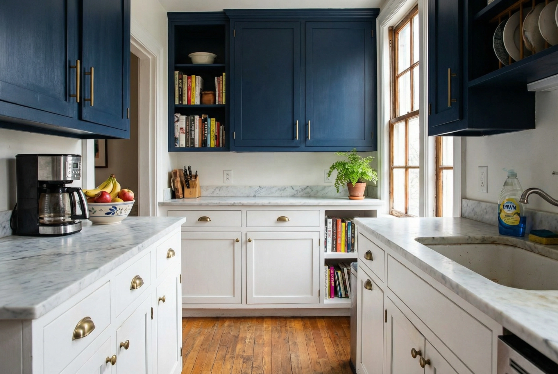 Two-tone kitchen cabinet painting in a DC Kalorama row house — navy uppers white lowers brass