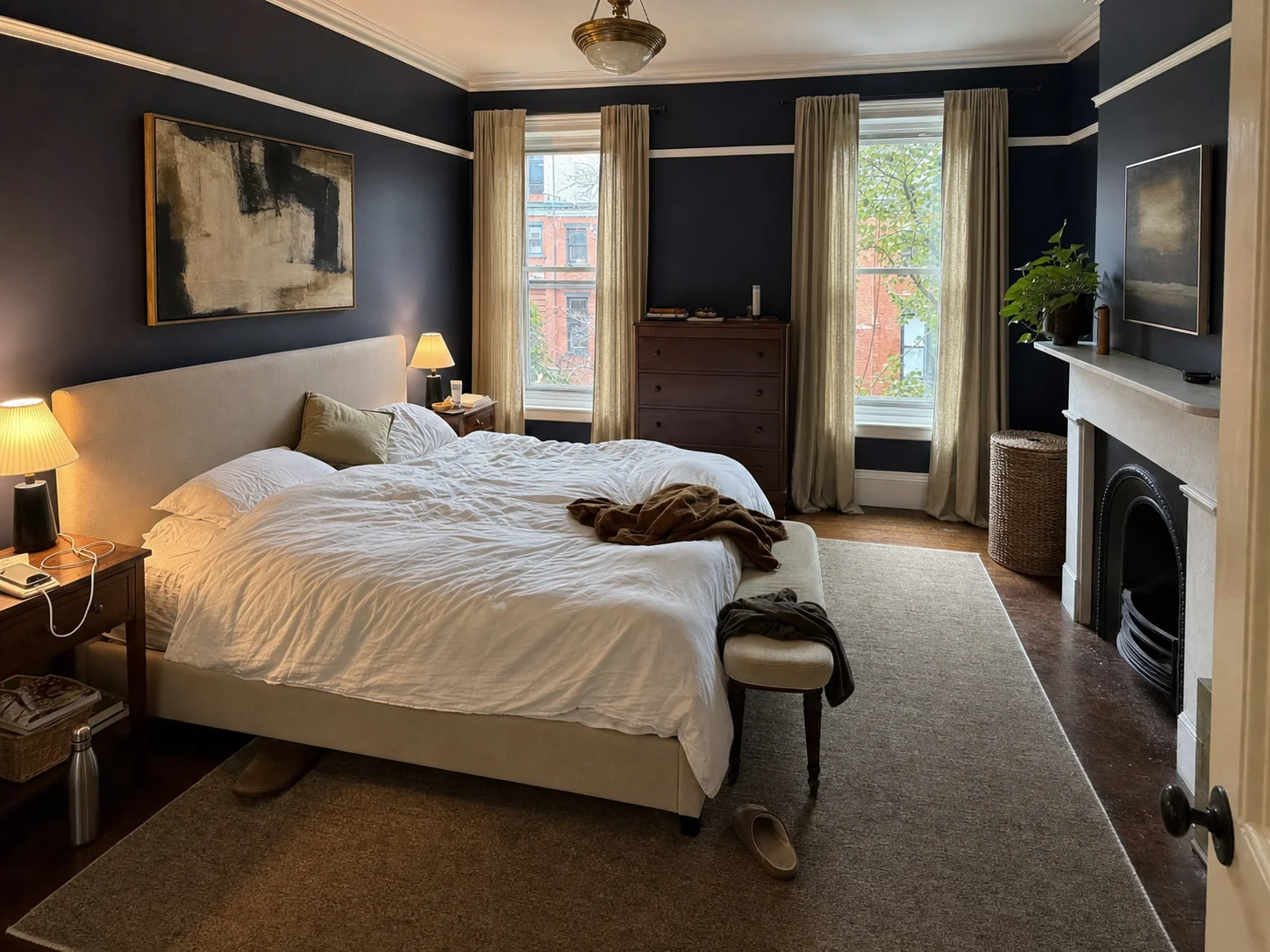 Primary bedroom painted a deep ink navy with white picture rail and trim after interior painting in Georgetown, Washington DC