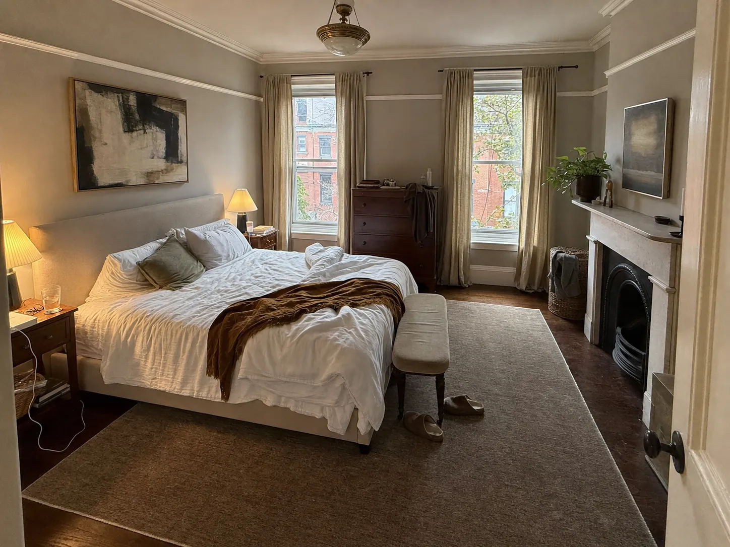 Soft gray primary bedroom with picture rail and marble fireplace before interior painting in Georgetown, Washington DC